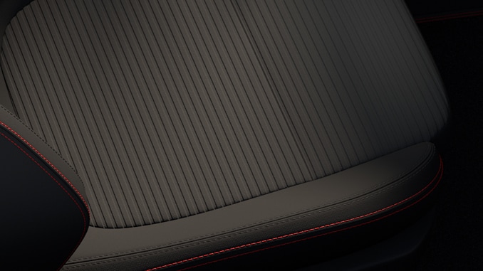 Stoffpolsterung in Anthrazit mit Ziernähten in Rot